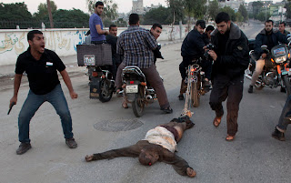 Palestinians drag body of suspected spy behind motorcycles in Gaza