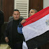 Mohamed Fahmy, journalist of Al Jazeera, holds up an Egyptian flag