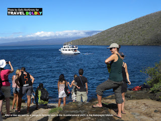 Travel Boldly Galapagos Island -  A group of hikers wait for a panga to ferry them back to the Guantanamera yacht.