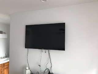 image of tv hung on wall with a wiring mess