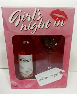 Gift set with wine, glass, and chocolates