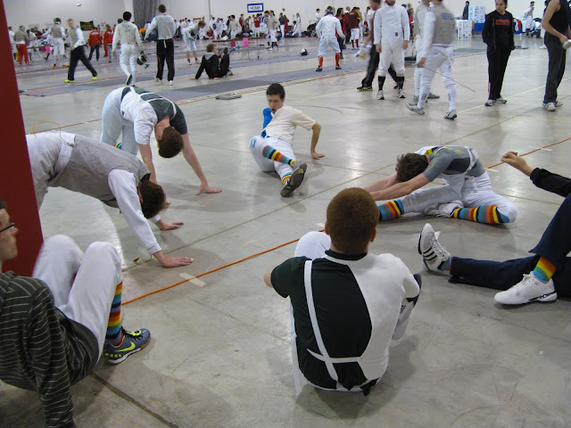 Team members stretch in a circle