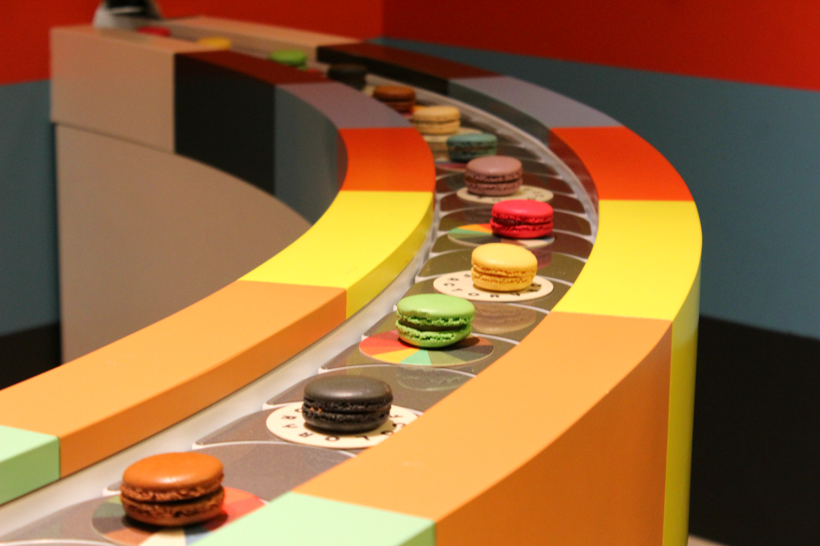 Macarons on a conveyor belt at Color Factory