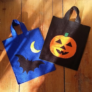 Picture of two trick or treat bags I made, a blue one with a bat and moon and a black one with an orange pumpkin