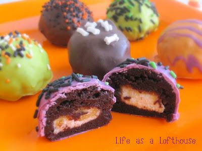 Brownie Cheesecake Bites are brownie balls with a cheesecake center that are covered in chocolate candy coating and sprinkles. Life-in-the-Lofthouse.com