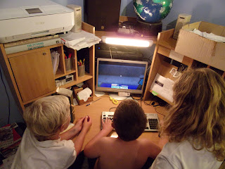 boys gathered around pc screen for minecraft