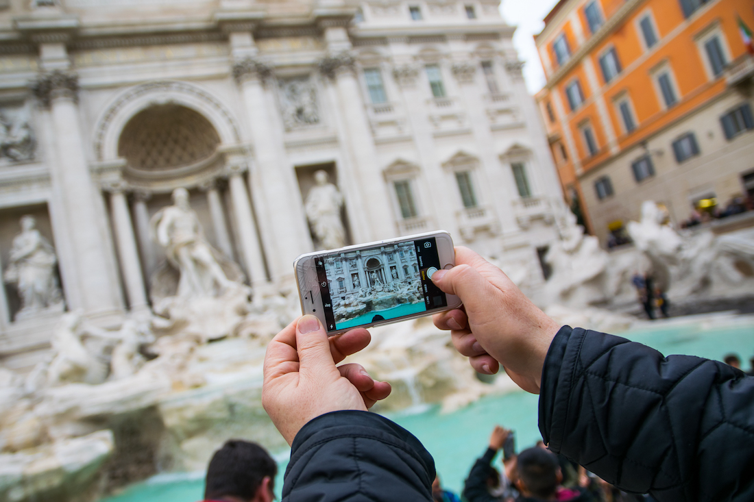 Taking photos of the Trevi Fountain in Rome