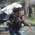 Syrian photographer puts down his camera to carry wounded children to safety