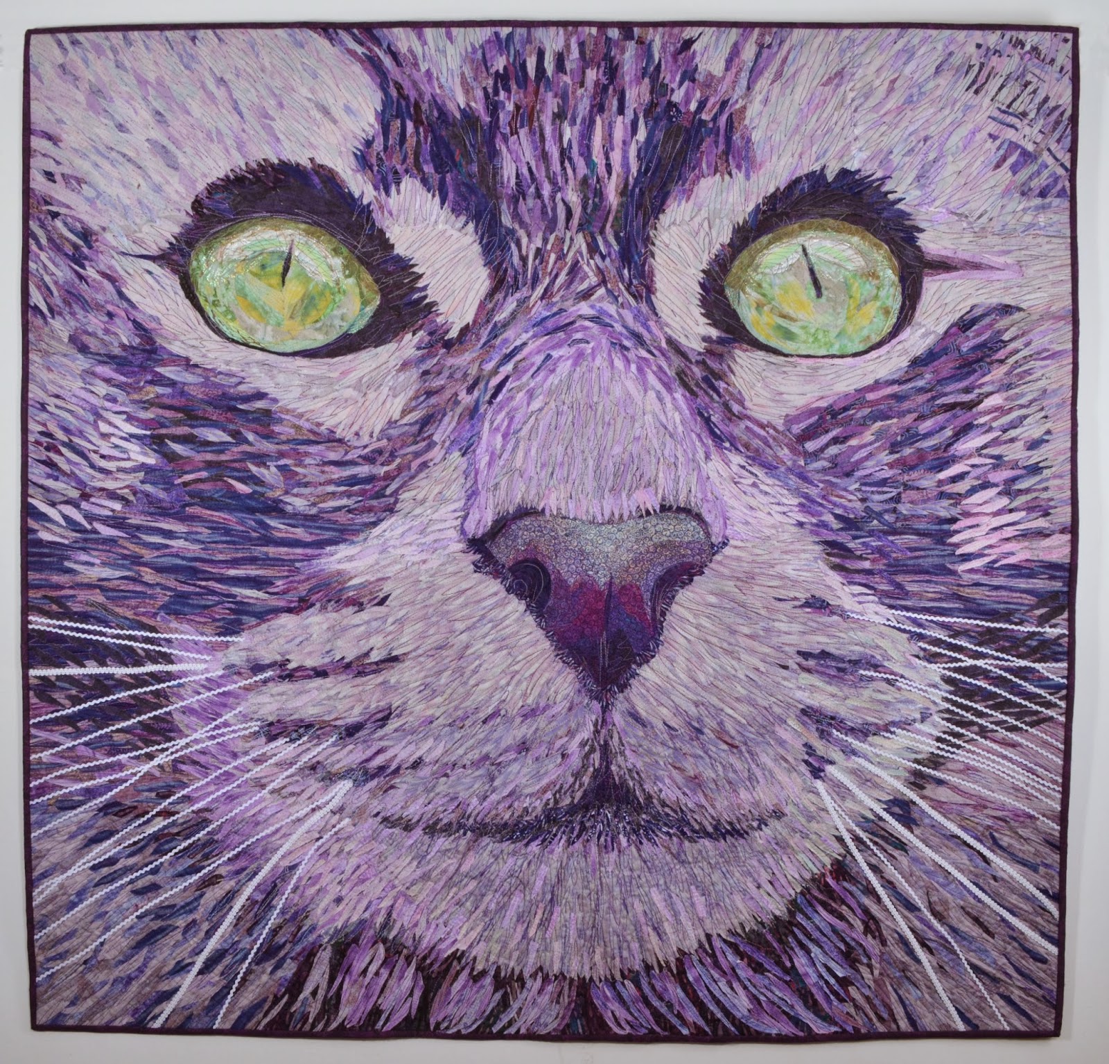 Fiber Obsession Cat  Face A portrait in purple  fabric of 