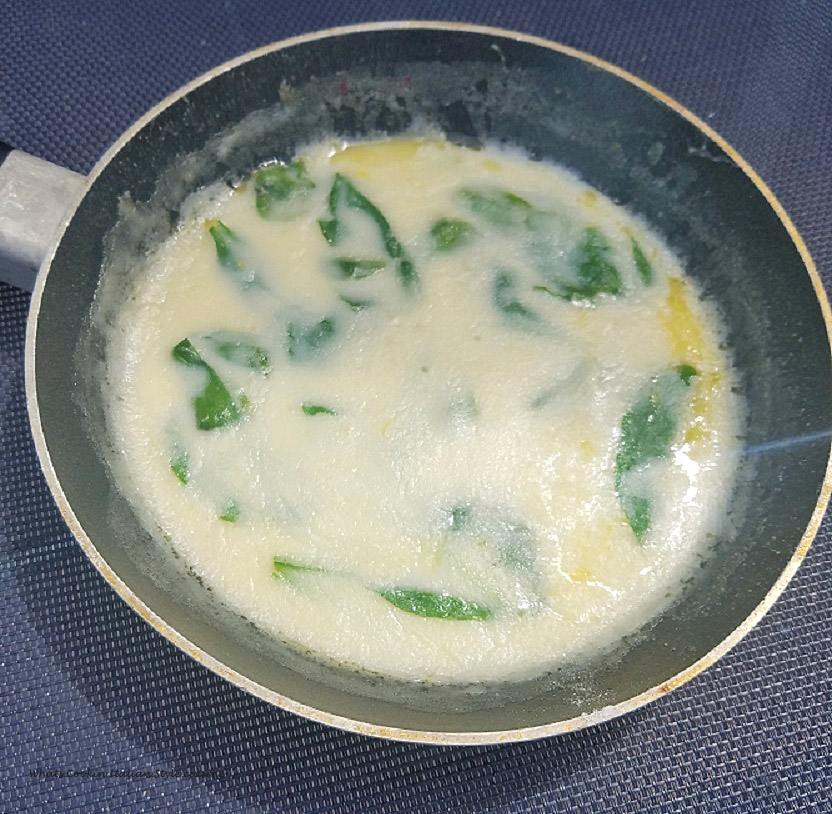 Spinach sauce in a pan with cream, radishes, lemon and fresh spinach for hamburgers or pasta great on fish too
