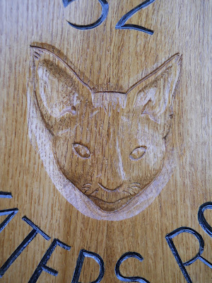 cat portrait carved in wood