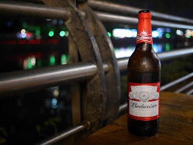 bottle of Budweiser Beer next to Jiangmen River