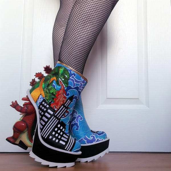 Irregular Choice Jurassotops side view of legs wearing blue ankle boots with green dinosaur on side breathing fire and dinosaur shaped heel