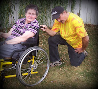 picture of caregiver tebowing behind wheelchair