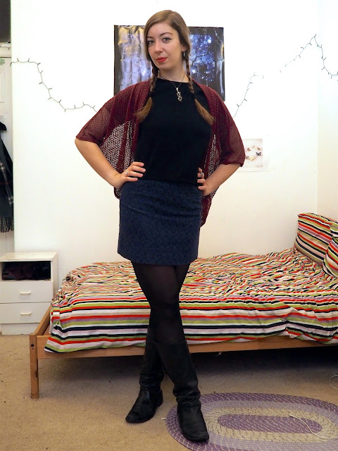 Anna Frozen Disneybound outfit of black t-shirt, short blue glitter skirt, pink lace cardigan, and tall black leather boots
