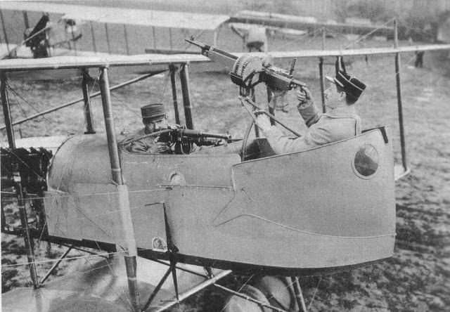French pilot and observer, sitting in a biplane, demonstrate arc of machine gun fire. The pusher planes made front mounted machine guns impossible. Dogfights and other stories of pilots. marchmatron.com French pilot and observer, sitting in a biplane, demonstrate arc of machine gun fire. The pusher planes made front mounted machine guns impossible. Dogfights and other stories of pilots. marchmatron.com