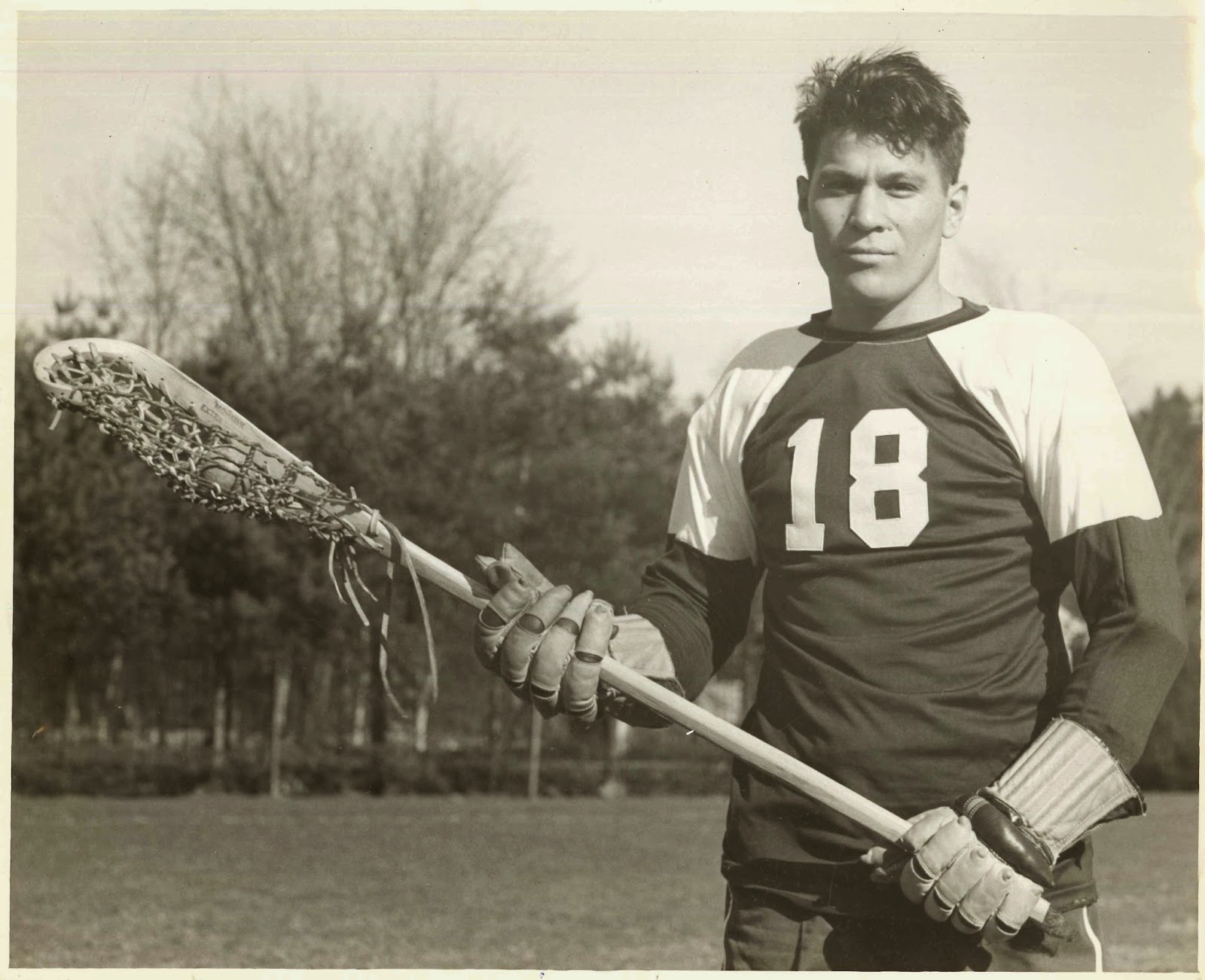 A photograph of a man in lacrosse gear.