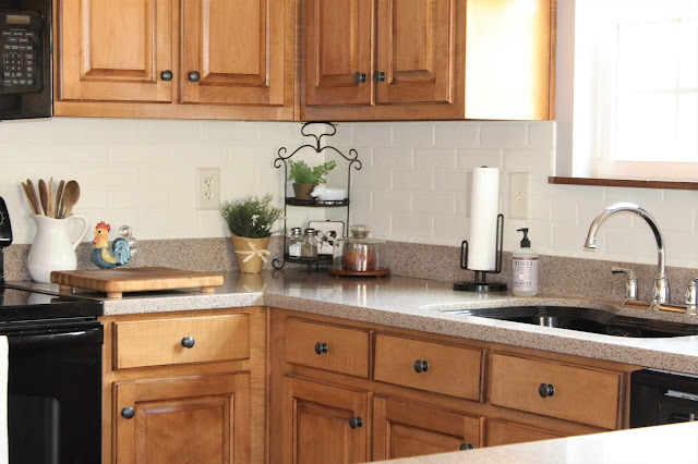 DIY painted faux brick backsplash in a cottage kitchen