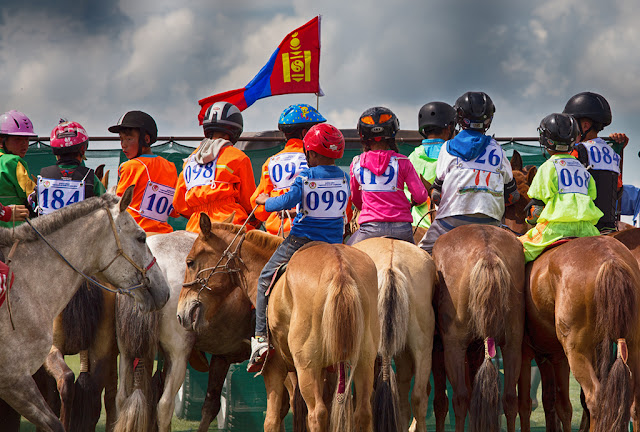 Lining up for the start of a horse race at the Bulgan Naadam in northern Mongolia. Distances covered range from 10 to 27 (!) km. Lining up for the start of a horse race at the Bulgan Naadam in northern Mongolia.