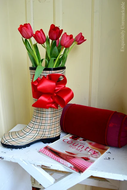 Rain boot tulip arrangement in a mudroom