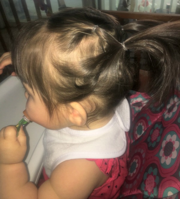 baby girl with a double pony tail double pony tail on a little girl