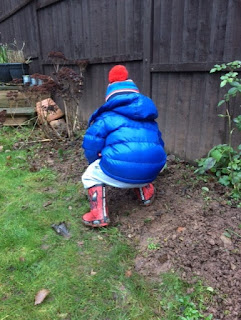 Little boy digging in the soil