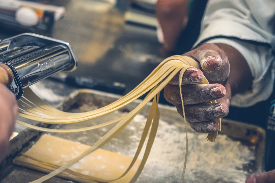 Cook preparing delicious pasta Cook preparing delicious pasta