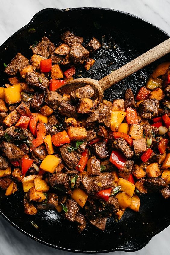 These Whole30 steak bites are packed with tons of flavor and huge pops of healthy vitamins and minerals thanks to colorful sweet potatoes, bell peppers, green onions, and fresh cilantro. This weeknight Whole30 dinner recipe takes one pan and is ready in under 45 minutes. It's an incredibly flavorful dinner you'll love whether you're on the Whole30 or not, and is also gluten free, dairy free, and totally kid friendly! #whole3 #steak These Whole30 steak bites are packed with tons of flavor and huge pops of healthy vitamins and minerals thanks to colorful sweet potatoes, bell peppers, green onions, and fresh cilantro. This weeknight Whole30 dinner recipe takes one pan and is ready in under 45 minutes. It's an incredibly flavorful dinner you'll love whether you're on the Whole30 or not, and is also gluten free, dairy free, and totally kid friendly! #whole3 #steak
