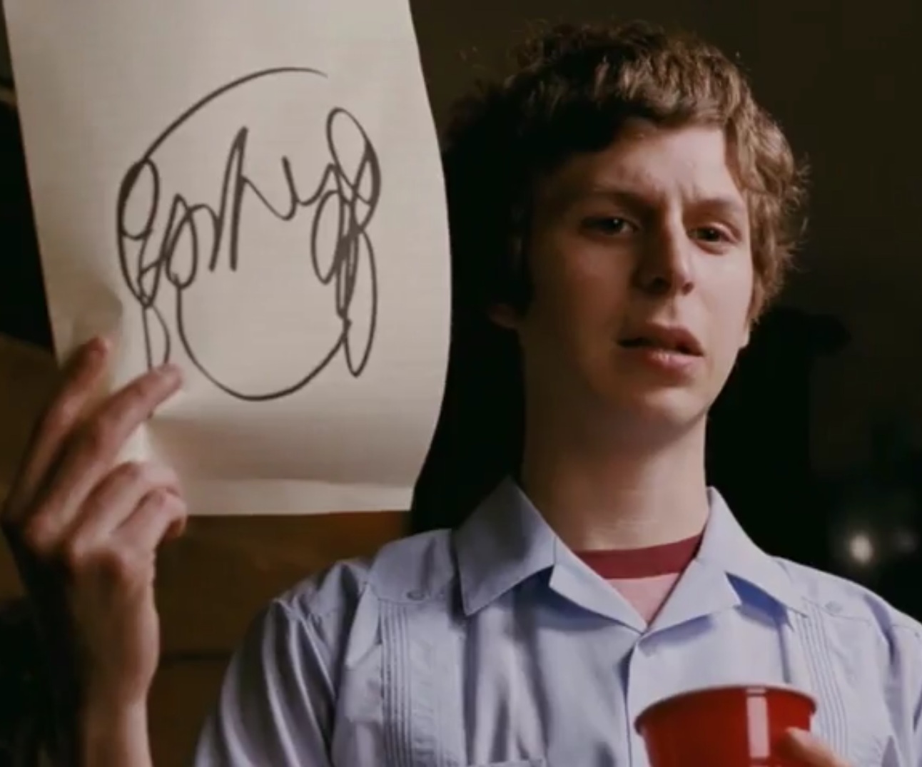 Scott Pilgrim holding up a messy sketch of Ramona Flowers' hairstyle