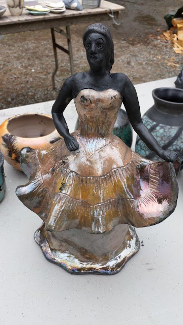 Raku fired pottery sculpture with glaze and unglazed areas.