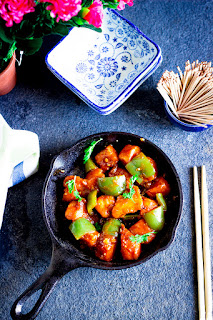 Batter fried tofu in a spicy chinese sauce with green capsicum