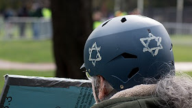 Person at antifascist rally wearing helmet with Star of David painted on it