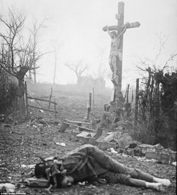 Carnage: Amid the appalling devastation and bodies of dead soldiers, a crucifix stands tall Carnage: Amid the appalling devastation and bodies of dead soldiers, a crucifix stands tall