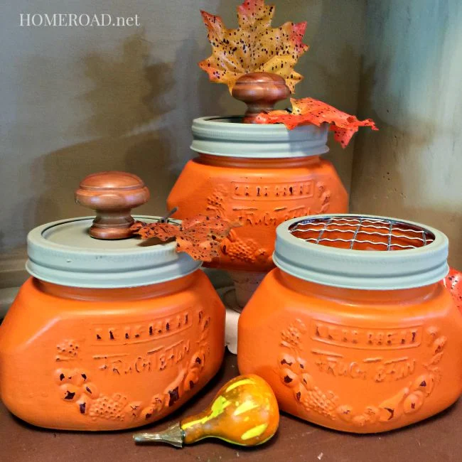 Orange painted mason jars with knob lids