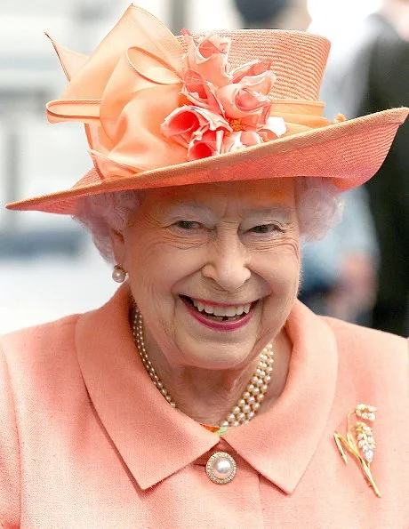 Queen Elizabeth II visited the new Highland Spring factory building in Blackford. The Queen style. wore pink coat and flower dress