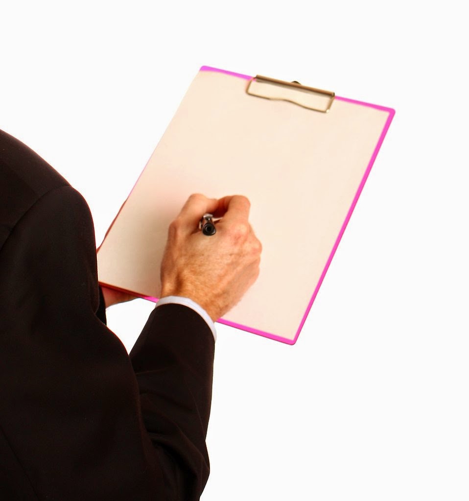 title: young businessman holding a clipboard and pen; take by: Benjamin Miller; source: http://www.freestockphotos.biz/