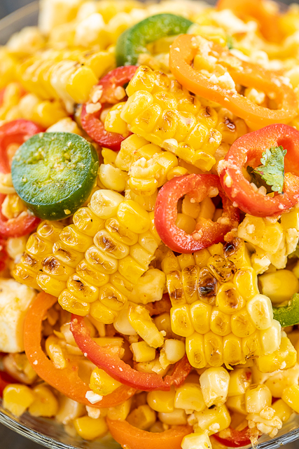Grilled Corn Salad - simple and delicious side dish! Grilled corn, sweet peppers, jalapeños, feta cheese tossed in honey, lime, olive oil, garlic, and cumin. Great with all your grilled dishes! Will keep in the refrigerator for several days. I made this for a cookout and it was gone in a flash!! YUM! #grilling #vegetable #sidedish #corn Grilled Corn Salad - simple and delicious side dish! Grilled corn, sweet peppers, jalapeños, feta cheese tossed in honey, lime, olive oil, garlic, and cumin. Great with all your grilled dishes! Will keep in the refrigerator for several days. I made this for a cookout and it was gone in a flash!! YUM! #grilling #vegetable #sidedish #corn
