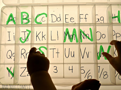 Matching and sorting transparent letters on the light table from And Next Comes L