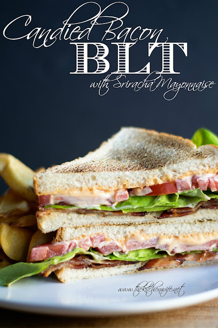 The finished candied bacon blt, on a plate, with fries.  