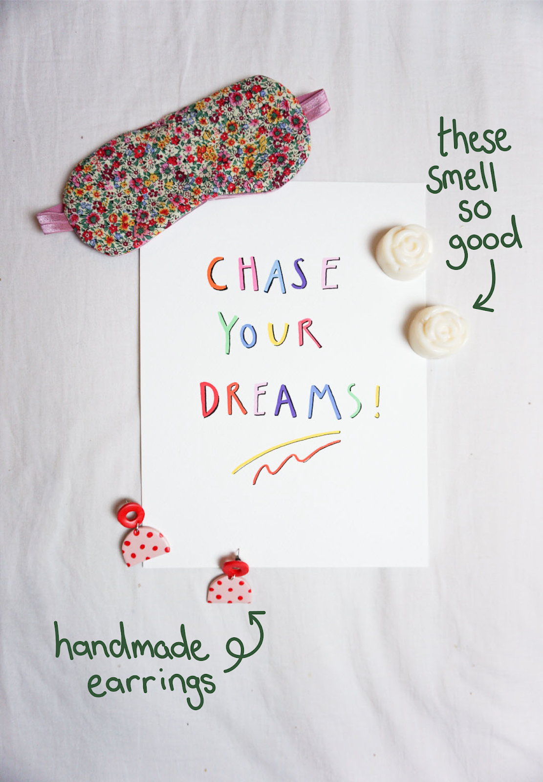 floral print sleep mask, colourful print reading "chase your dreams", cream rose wax melts and pink and red print statement earrings