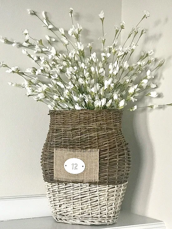 repurposed basket with tag filled with flowers