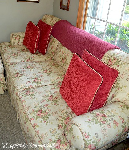 Floral sofa with red pillows