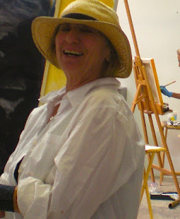 Sefla Joseph teaching art class, big grin on her face