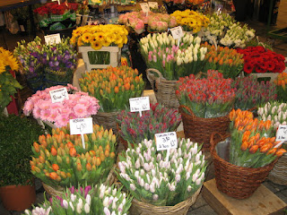 Baskets of tulips and other flowers at a stall in the Flower Market, Amsterdam, The Netherlands