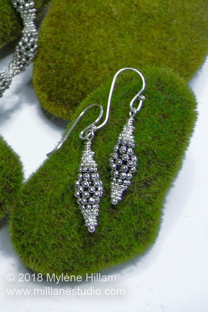 Olive shaped silver earrings made with stacked daisy spacers