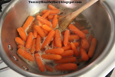 Pan filled with cooking Brown Sugar Glazed Carrots - carrots, brown sugar, butter and rosemary. (step by step instructions)