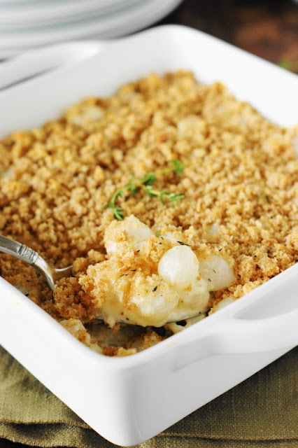 Creamed Pearl Onion Gratin ~ Tender pearl onions baked in creamy cheesy sauce, delicately seasoned with fresh thyme crumb topping. They're a perfect Thanksgiving or holiday side.  www.thekitchenismyplayground.com
