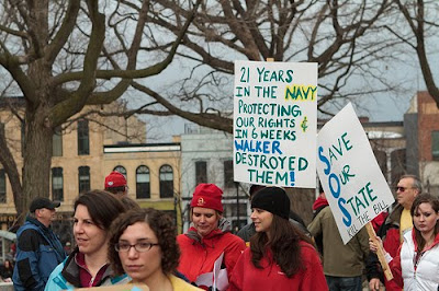 Protest with sign that says, 21 years in the Navy protecting our rights, and in 6 weeks Walker destroyed them.