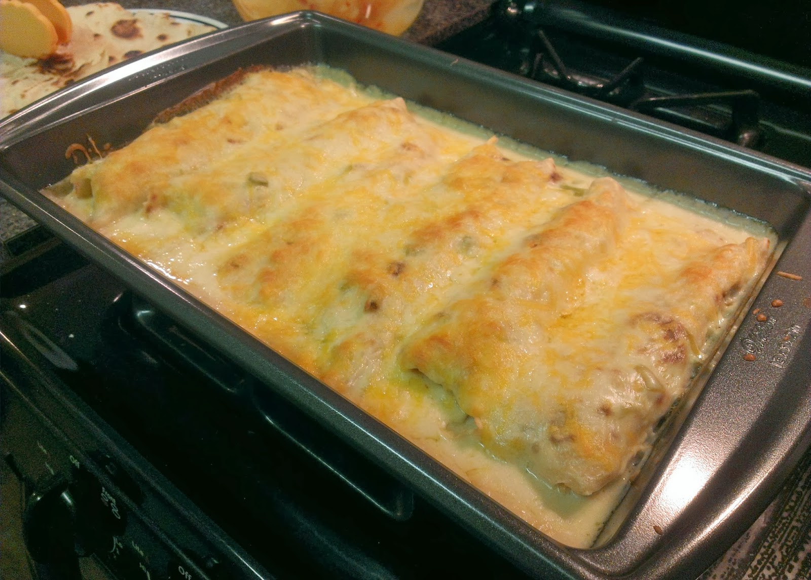 The Hungry Hood Chicken Enchiladas with a Green Chili & Sour Cream Sauce