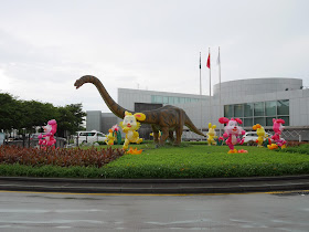Mid-Autumn Festival lanterns and a large dinosaur on display in front of the Macau Science Center